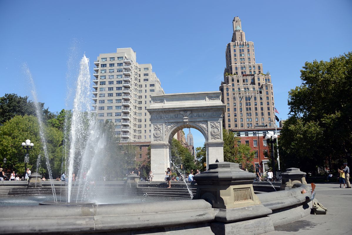 07 New York Washington Square Park Fountain And Wahington Arch With 2 Fifth Ave, Empire State Building, One Fifth Ave